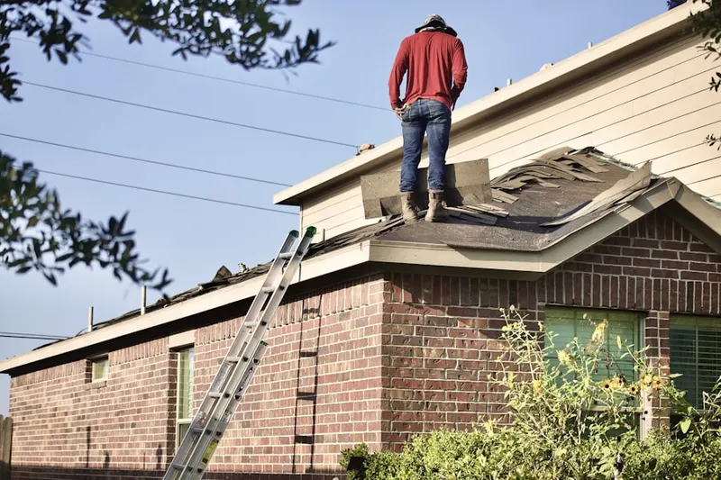 Professional roofer working on a residential roof in Valley Ranch